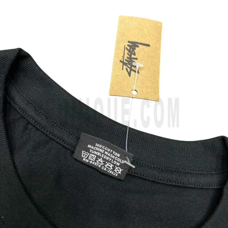 Neckline tag close-up, displaying garment care symbols and brand information with fashion-forward presentation.