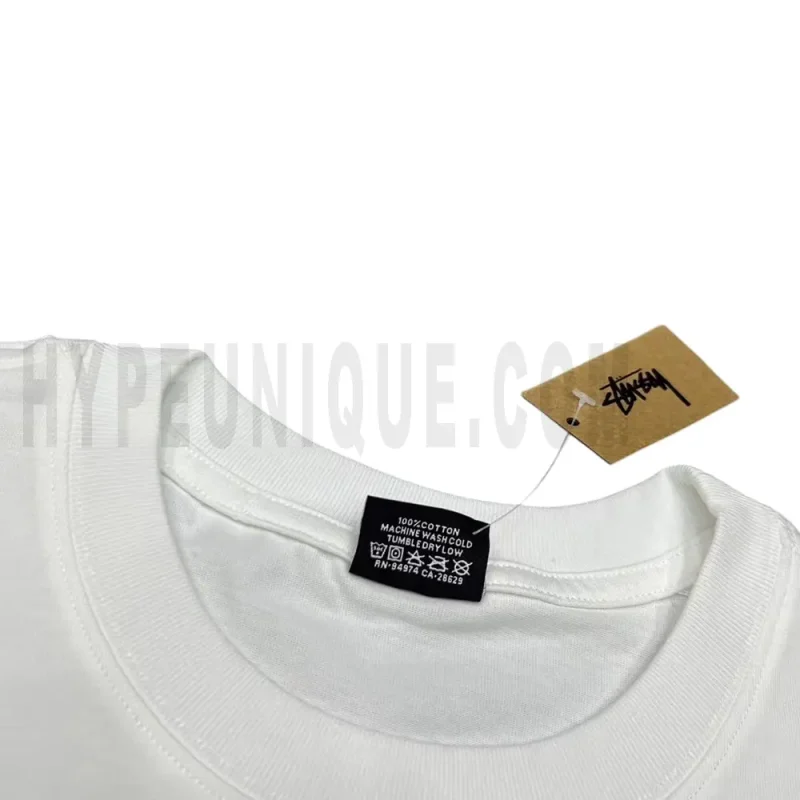 Neckline tag close-up, displaying garment care symbols and brand information with fashion-forward presentation.