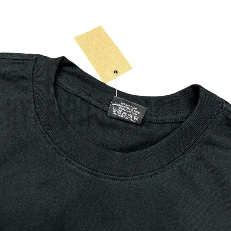 Neckline tag close-up, displaying garment care symbols and brand information with fashion-forward presentation.