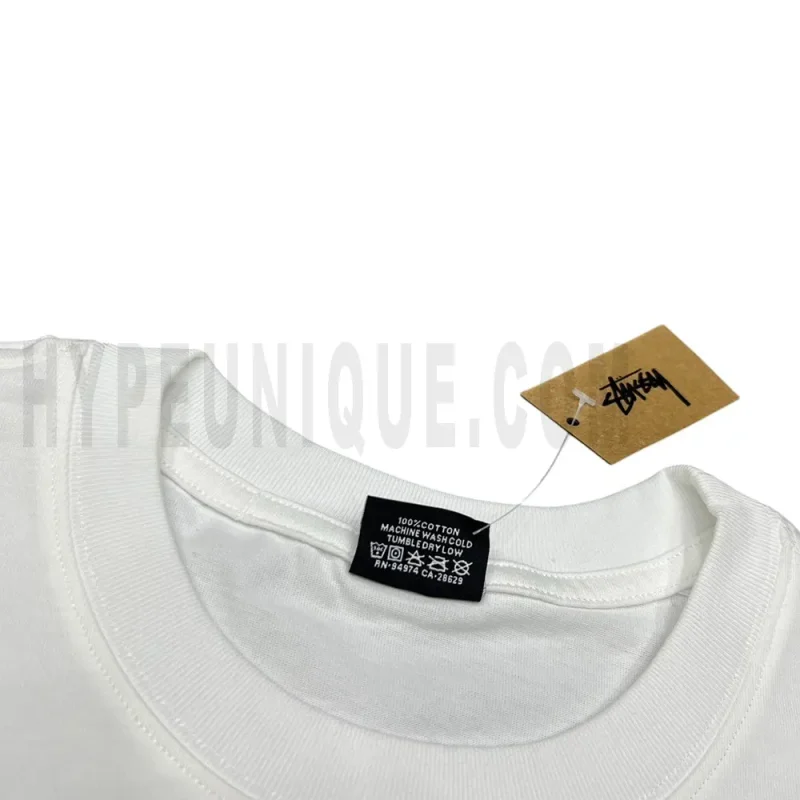 Neckline tag close-up, displaying garment care symbols and brand information with fashion-forward presentation.