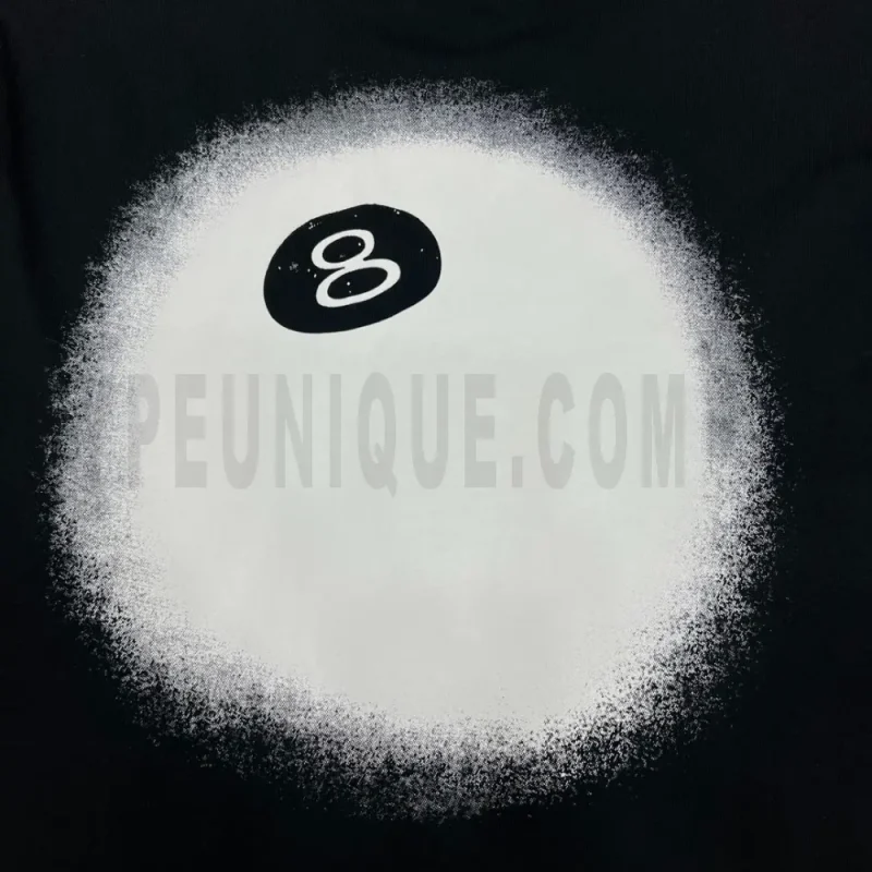 Detailed shot capturing the graphic print on the black tee's back panel.