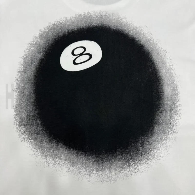 Detailed shot capturing the graphic print on the white tee's back panel.