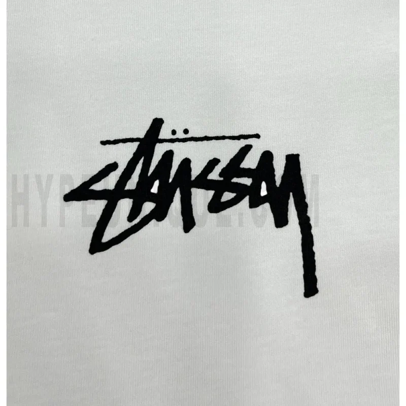 Detailed shot capturing the graphic print on the white tee's front panel.