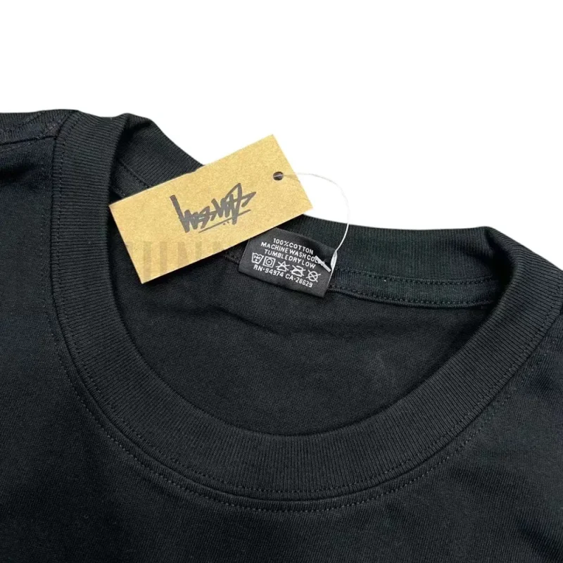 Neckline tag close-up, displaying garment care symbols and brand information with fashion-forward presentation.