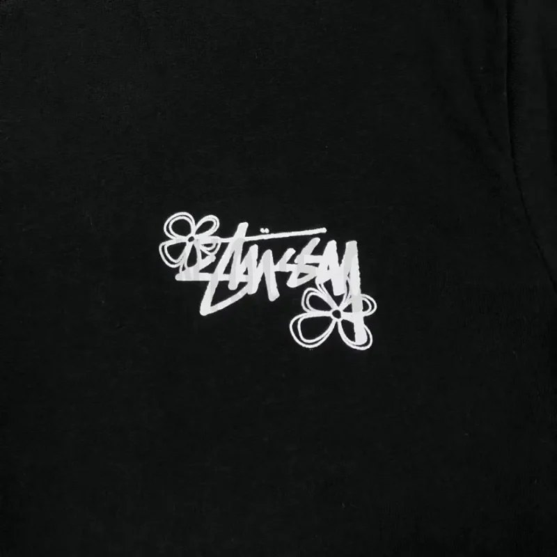 Detailed shot capturing the graphic print on the black tee's front panel.
