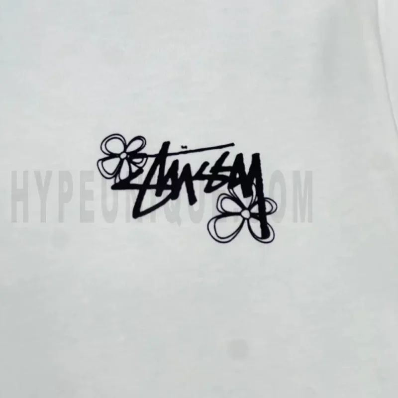 Detailed shot capturing the graphic print on the white tee's front panel.