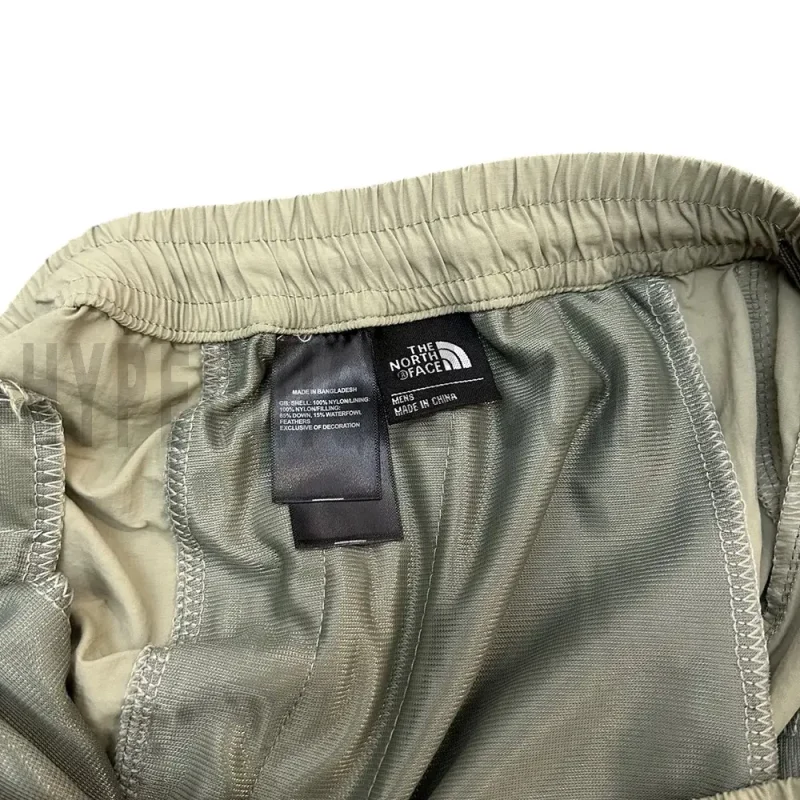 Close-up of the short's tag, showcasing wash care instructions and brand details in a fashion design.
