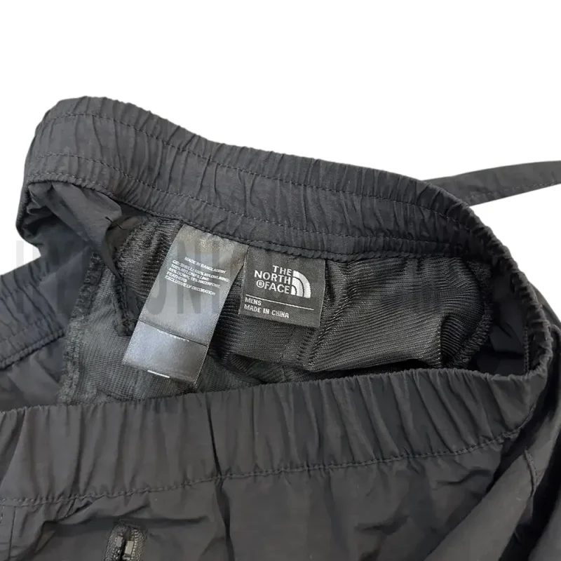 Close-up of the short's tag, showcasing wash care instructions and brand details in a fashion design.