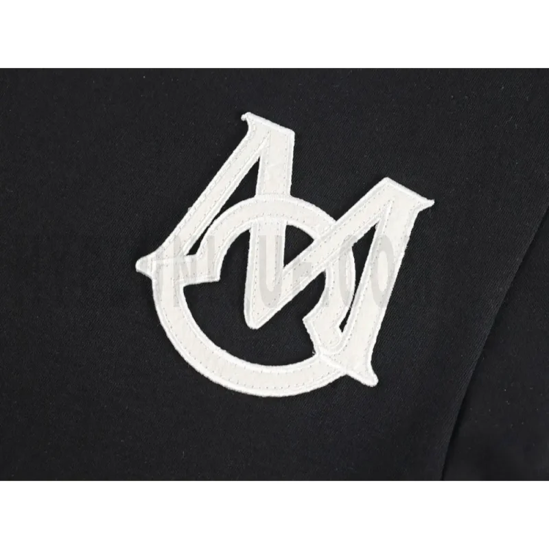 Detailed shot capturing the graphic print on the black tee's front panel.