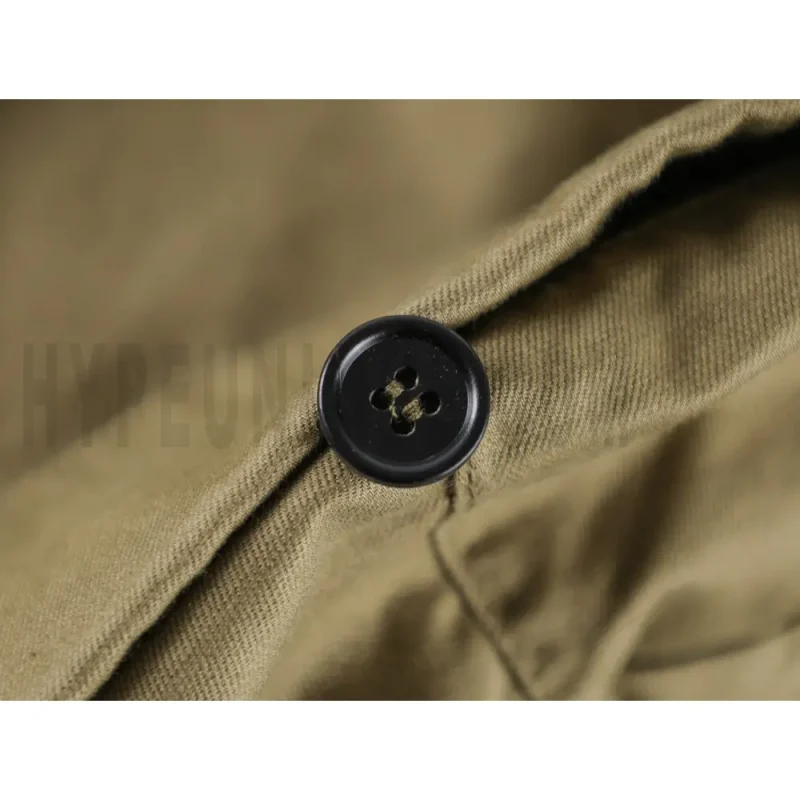 Close-up of button detail on the pants.