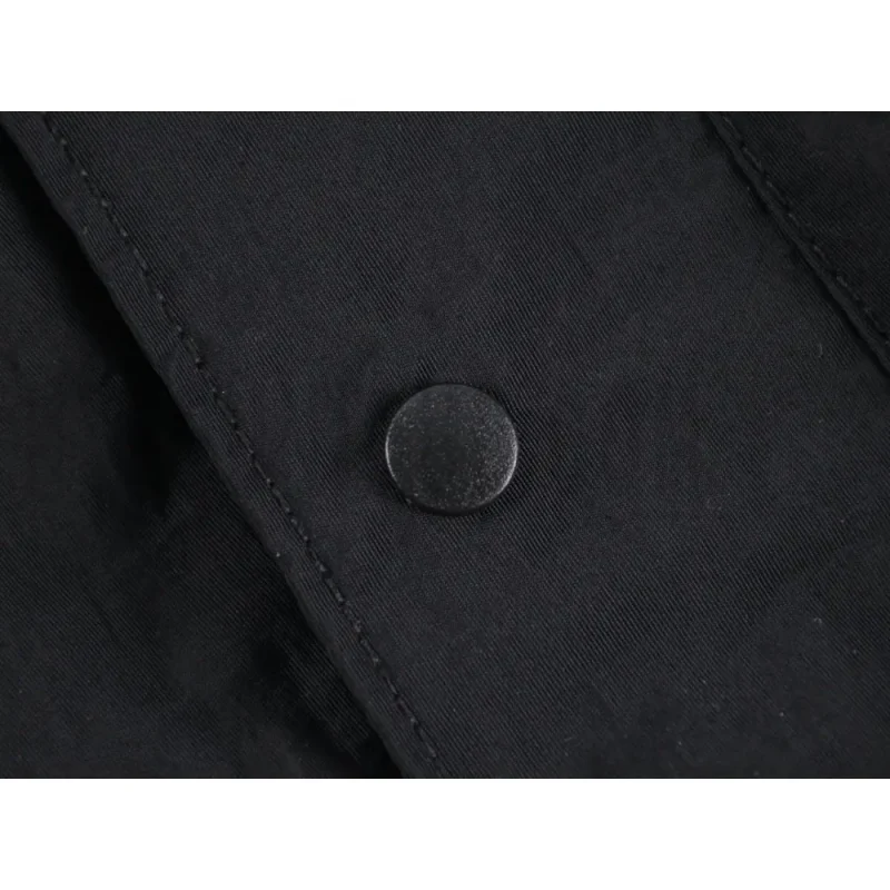 Close-up of button detail on the pants