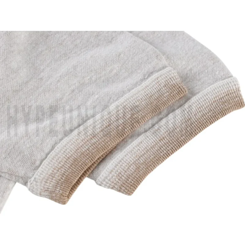 The sleeves of the beige clothes