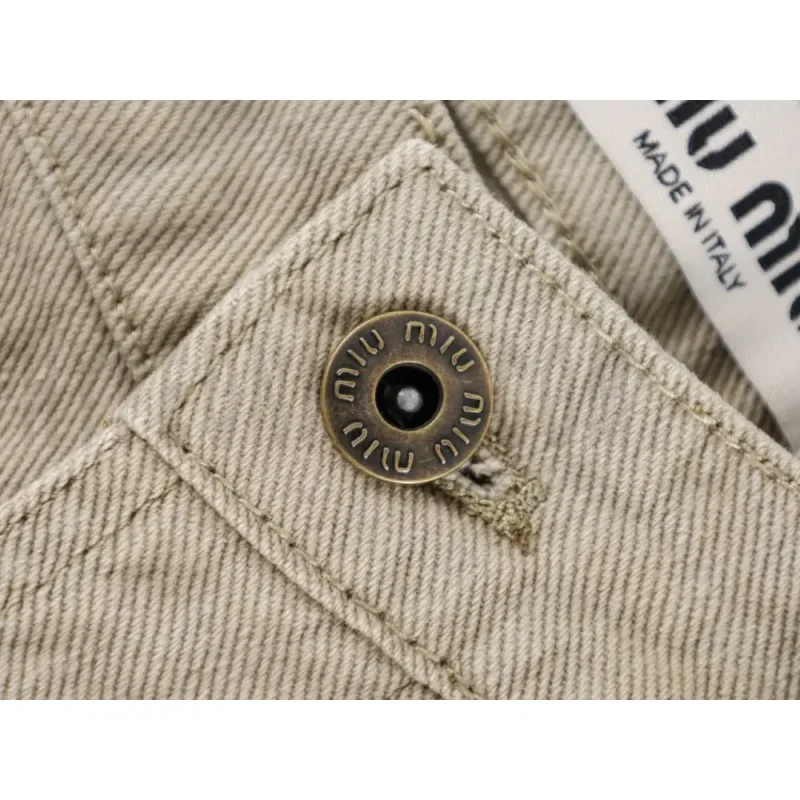 Close-up of button detail on the pants