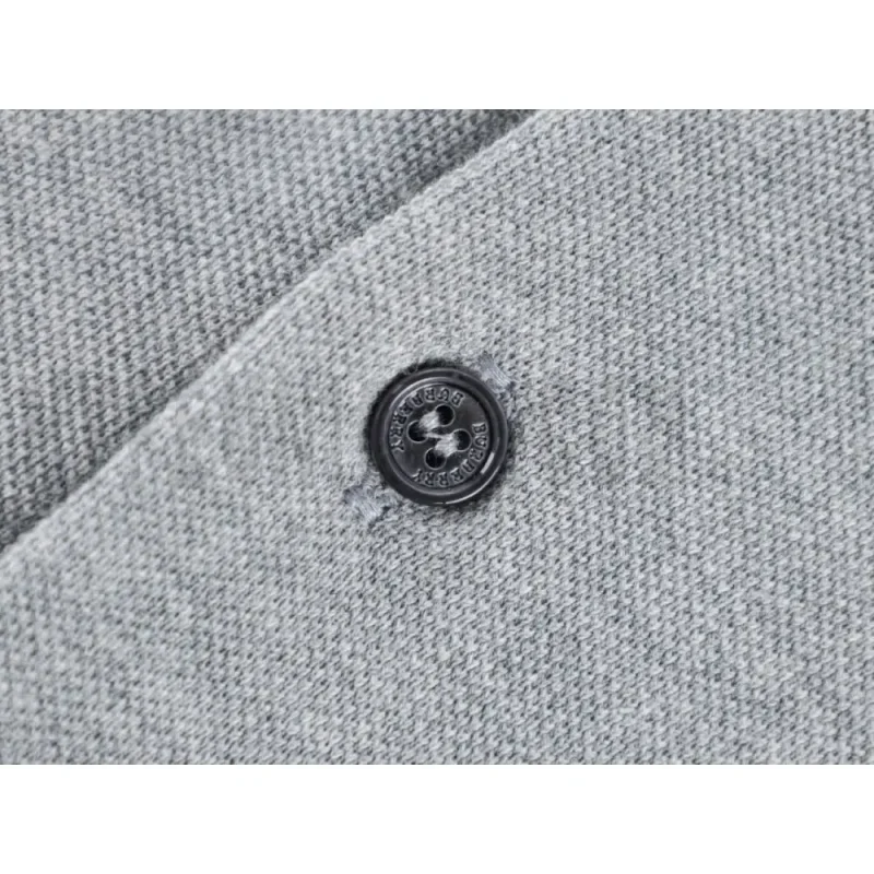 Close-up of button detail on the garment