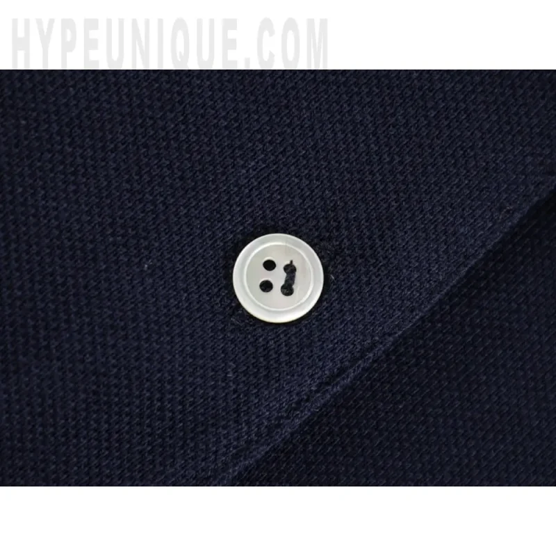 Close-up of button detail on the clothes